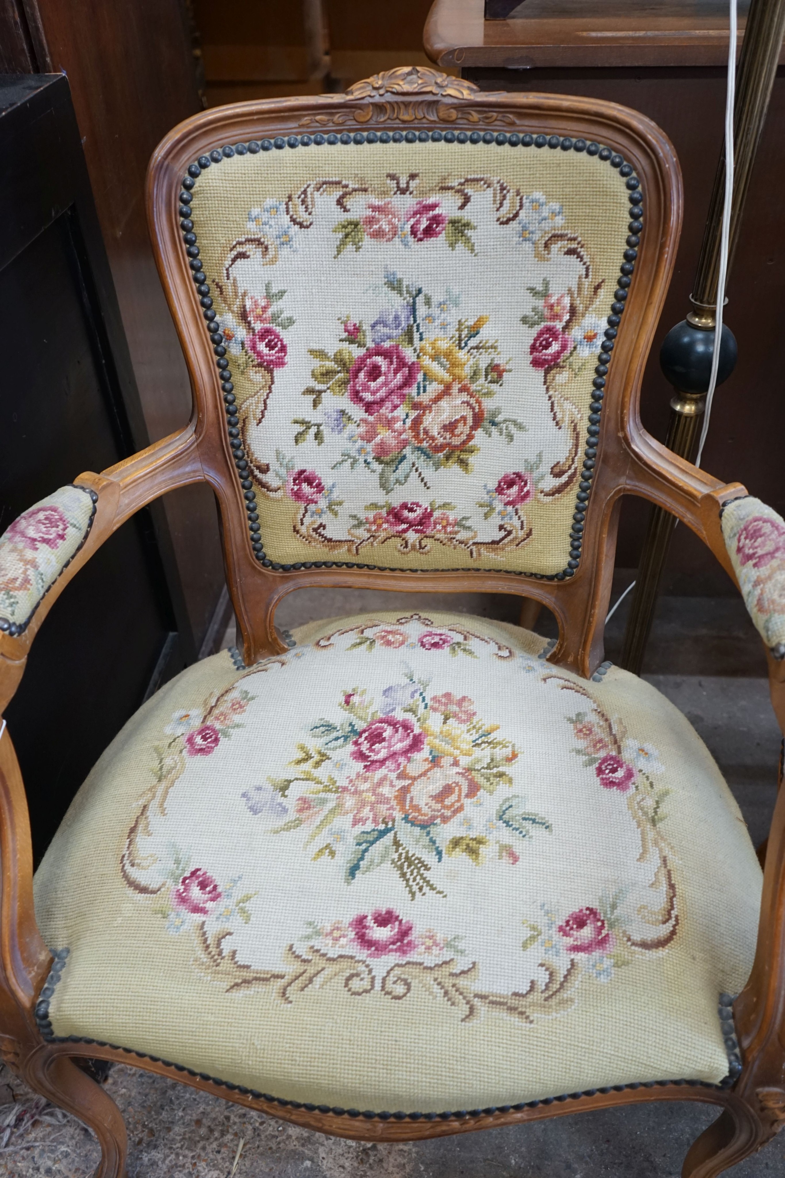 A pair of Louis XVI style carved beech fauteuils